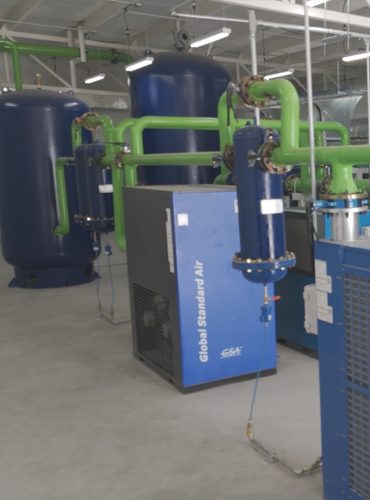 Air receivers and dryer in the finished compressor room.