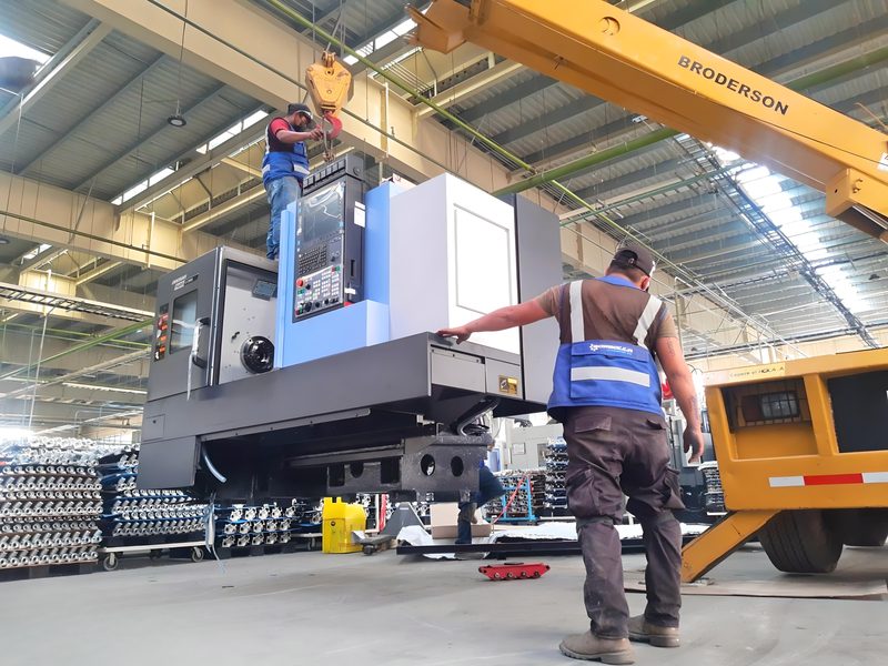 Machine lowered into position with a carry-deck crane.