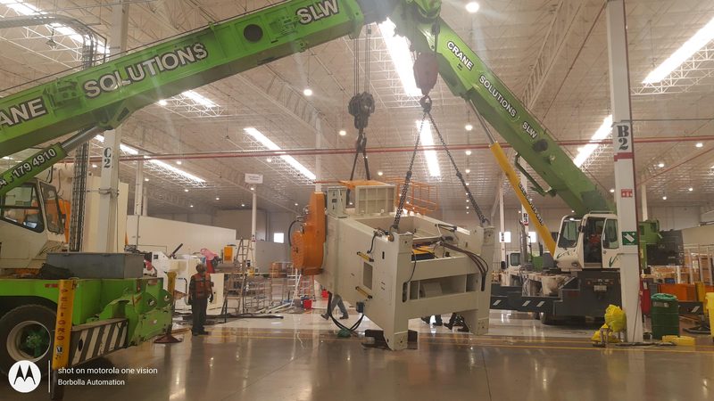 Press lifted clear with two cranes working together.