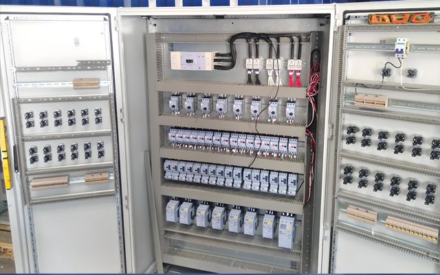 Panel internals: breakers, contactors and terminal rails.