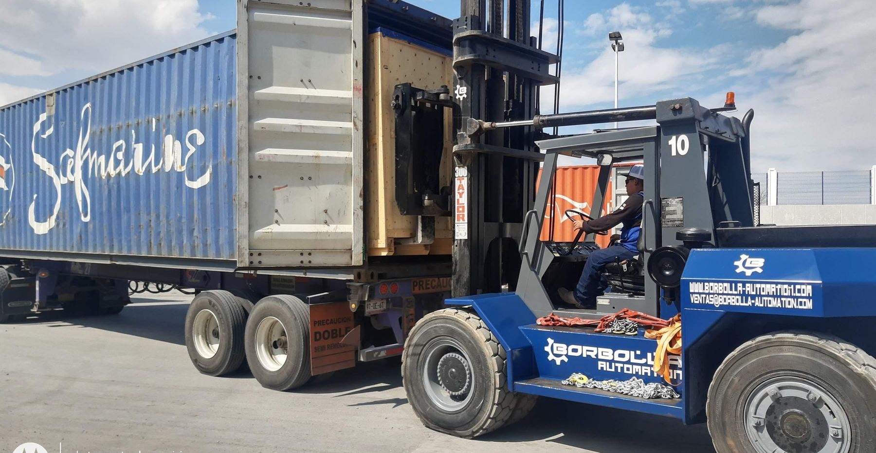 A crated machine drawn out of the shipping container by our own 30-tonne forklift.