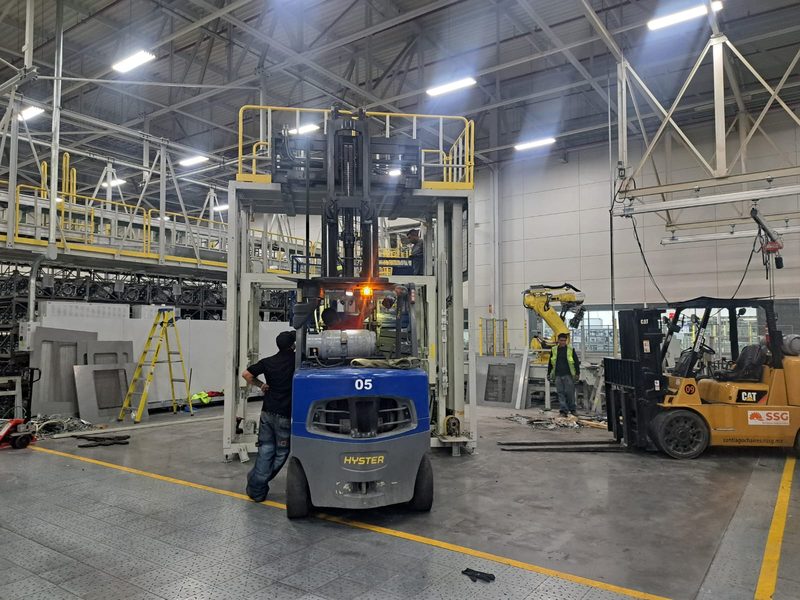 Machine positioned under the mezzanine with a counterbalance forklift.