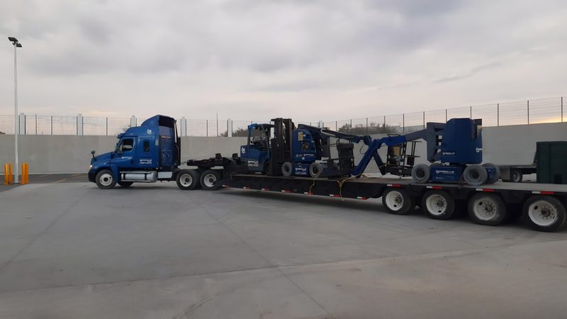 Our own tractor and lowboy delivering equipment to site.