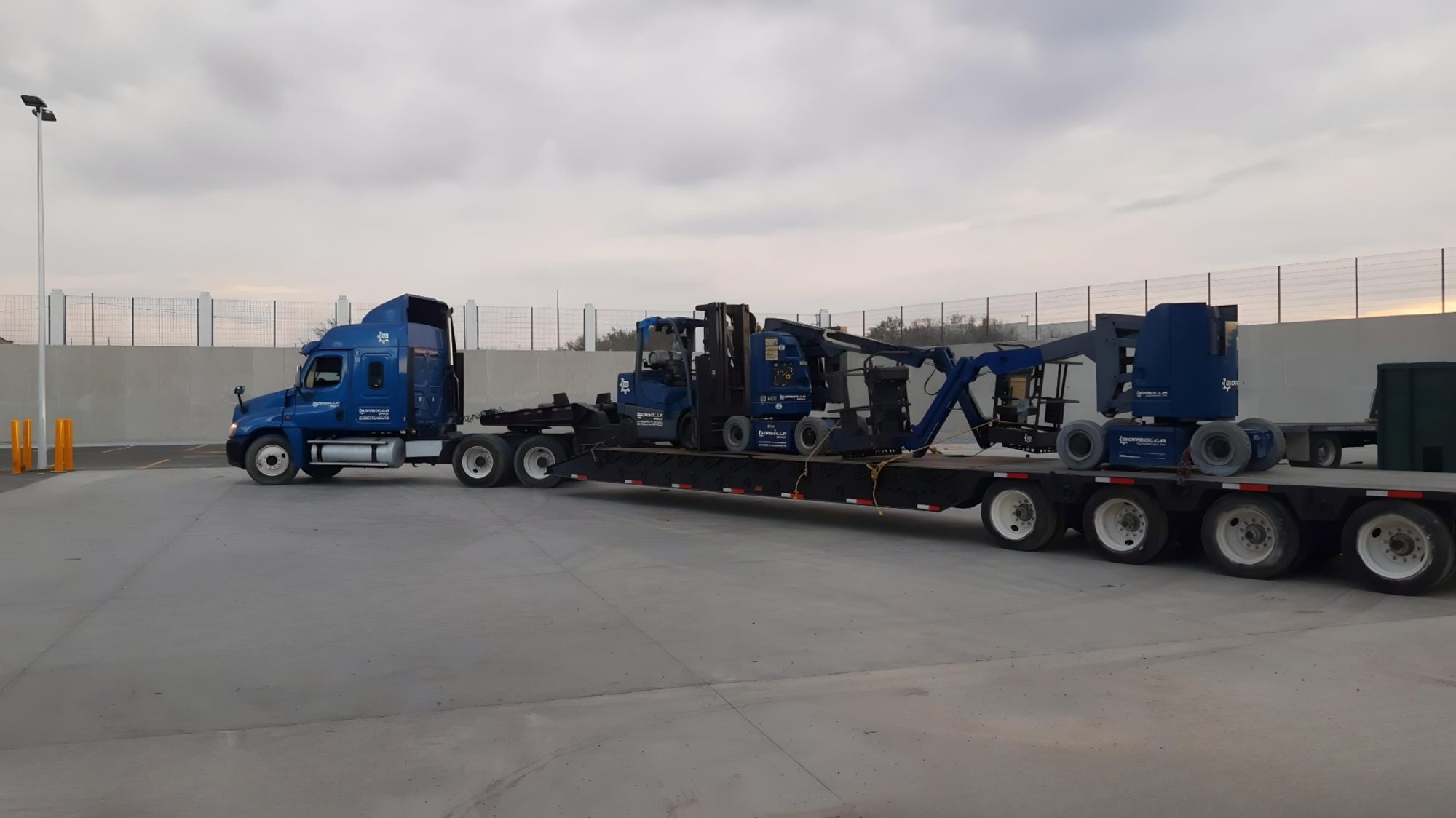 Borbolla tractor and lowboy loaded with a heavy forklift and boom lift